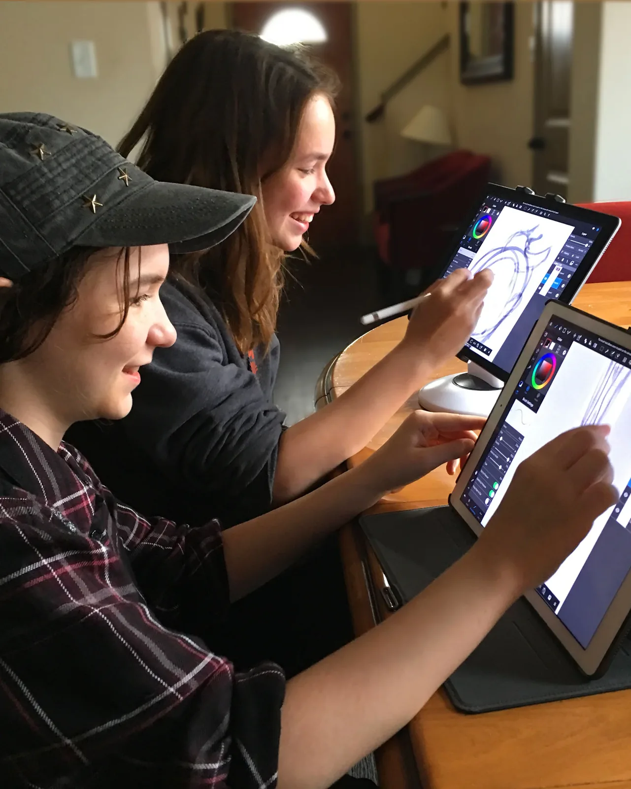 Two young students drawing on tablets in a MentorWings class